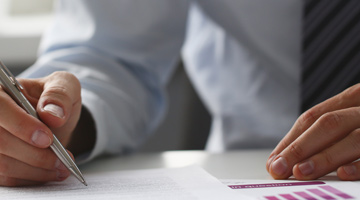 person writing a business report